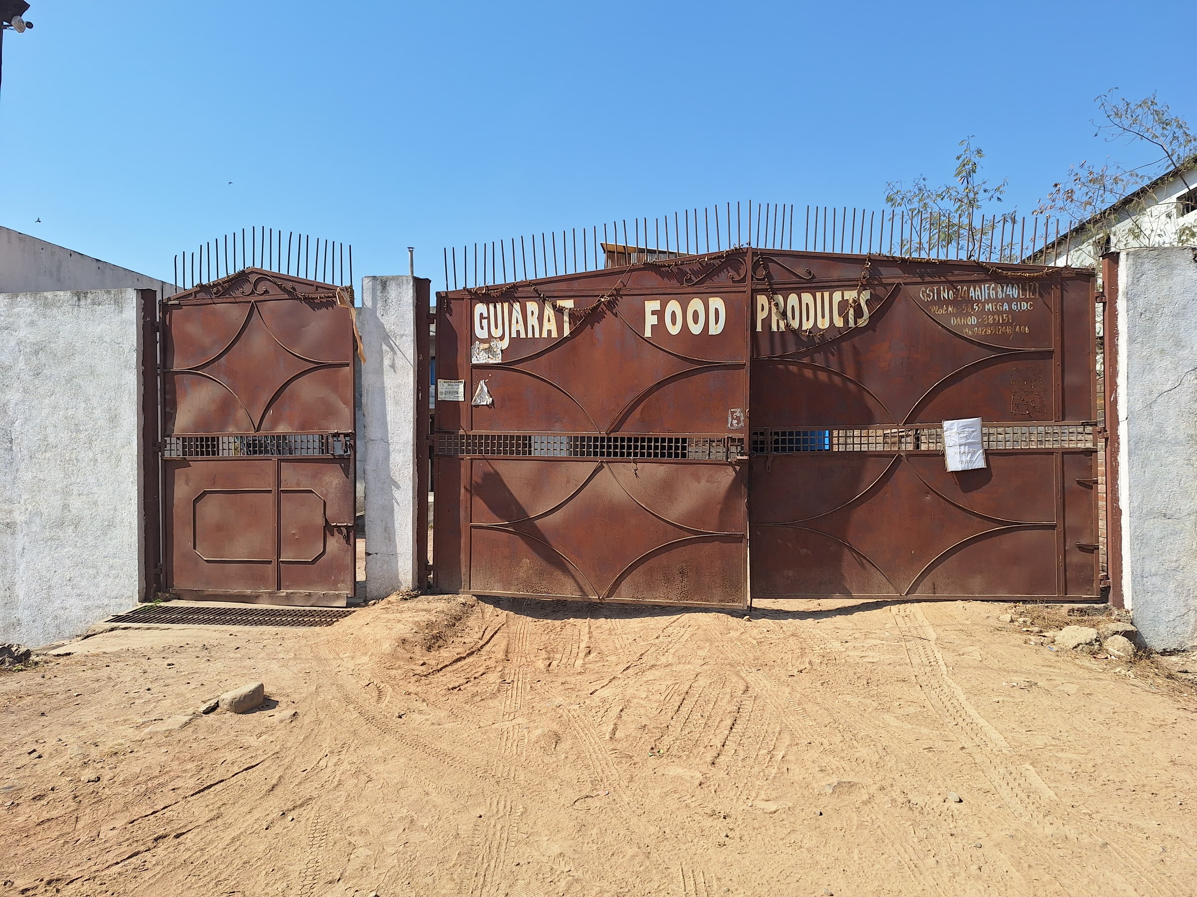 The painted metal gate of the Gujarat Food Products works in Dahod